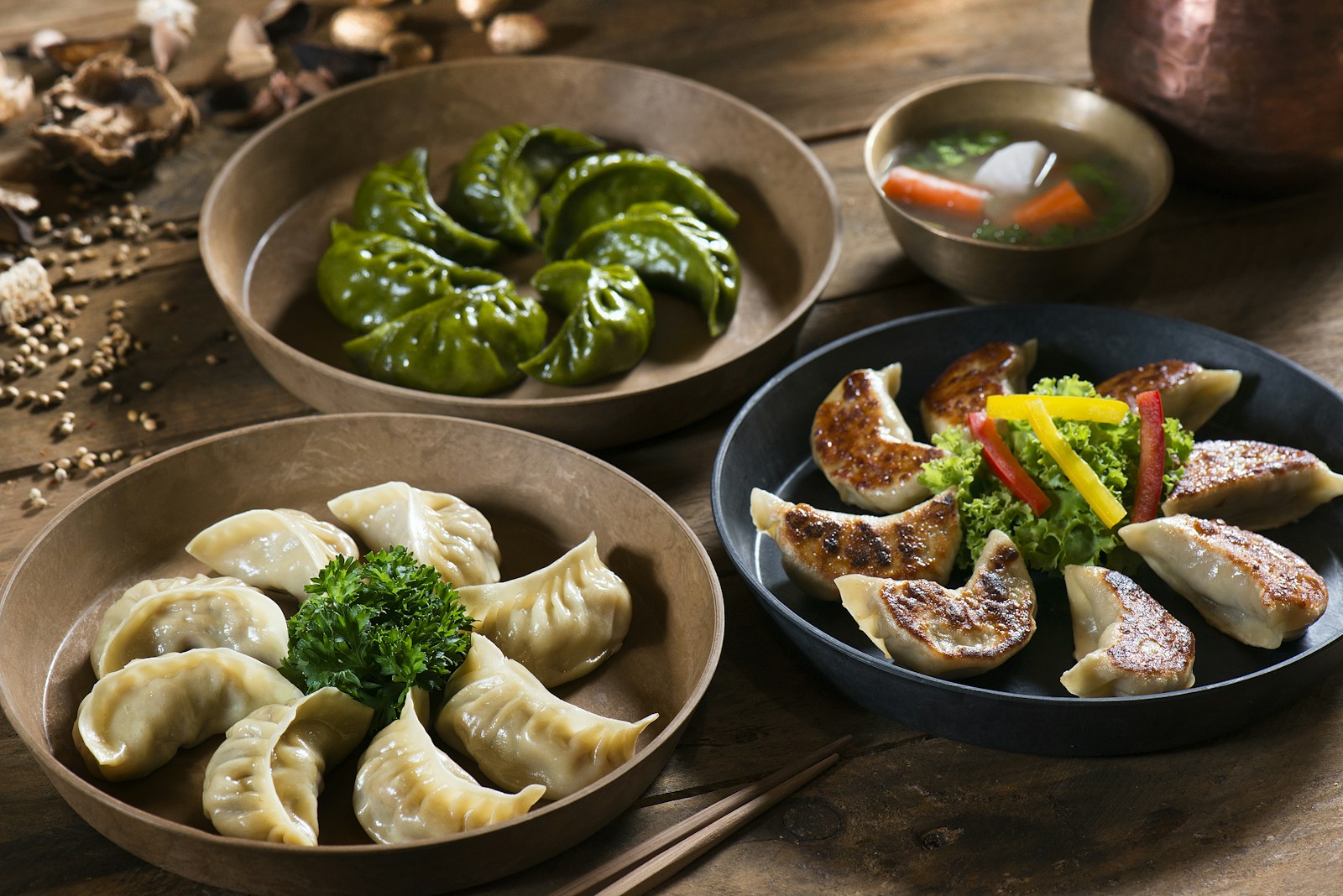 A plate of momo dumplings with dipping sauce, illustrative food photograph